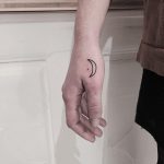 Hand-poked moon tattoo on the hand