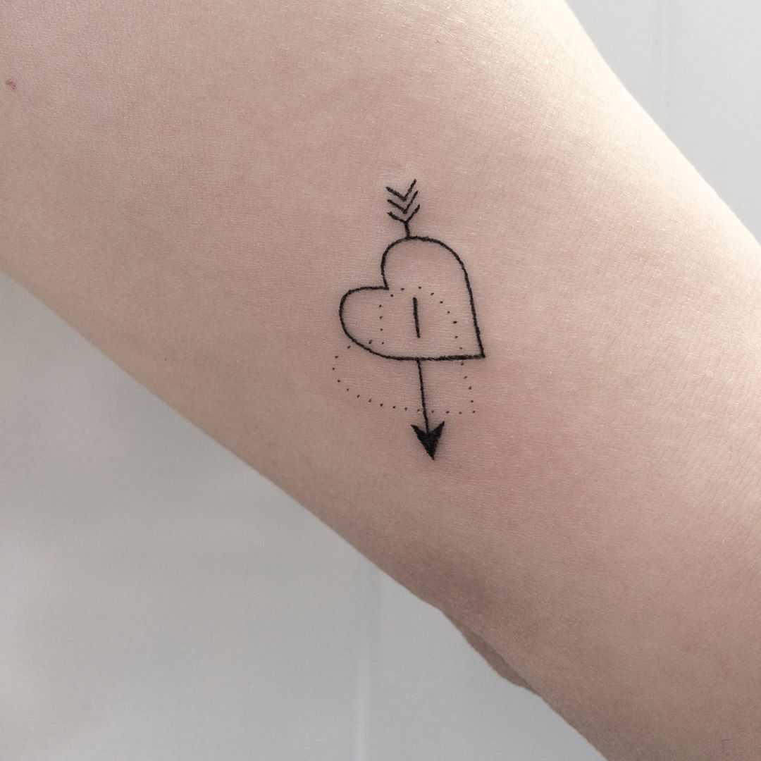 Hand-poked shot heart tattoo