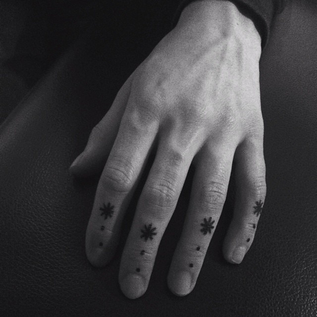 Hand-poked small finger tattoos