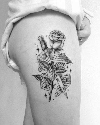 Knife, rose, and demolished house tattoo