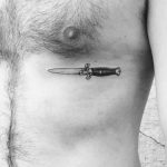 Knife tattoo on the rib cage