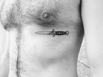 Knife tattoo on the rib cage