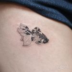 Koi fish tattoo on the thigh