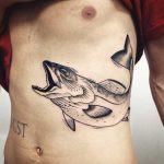 Large fish tattoo on the rib cage