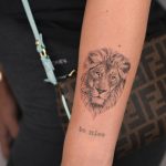 Lion head tattoo on the forearm