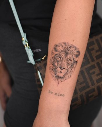 Lion head tattoo on the forearm