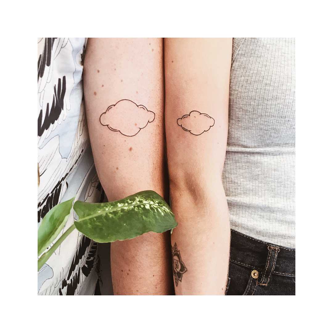 Matching cloud tattoos for a couple