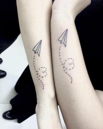 Matching paper plane tattoos