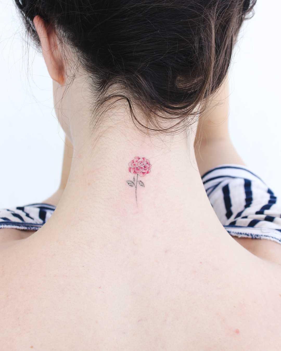 Premium Photo | A tattoo of a bird with a flower on the neck