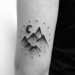 Mountains in a dotted circle tattoo