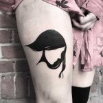 Negative space girl tattoo on the thigh