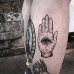 Occult hand tattoo on the calf