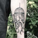 Octopus in a cage tattoo