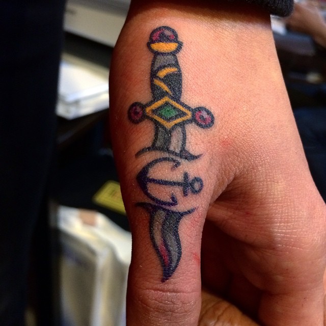 Old-school tiny dagger and anchor tattoo