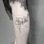 Orchids tattoo on the calf