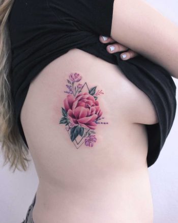 Peony tattoo on the rib cage by Iris Tattoo Art