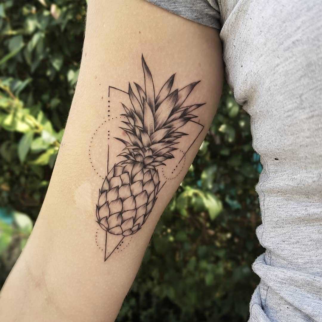 Pineapple and triangle tattoo on the arm