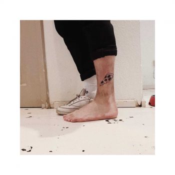 Pizza slice tattoo on the calf