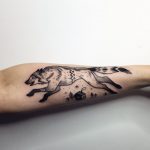 Running wolf tattoo by Sasha Tattooing