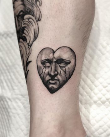 Sad stone face done at Lighthouse Professional Tattoo