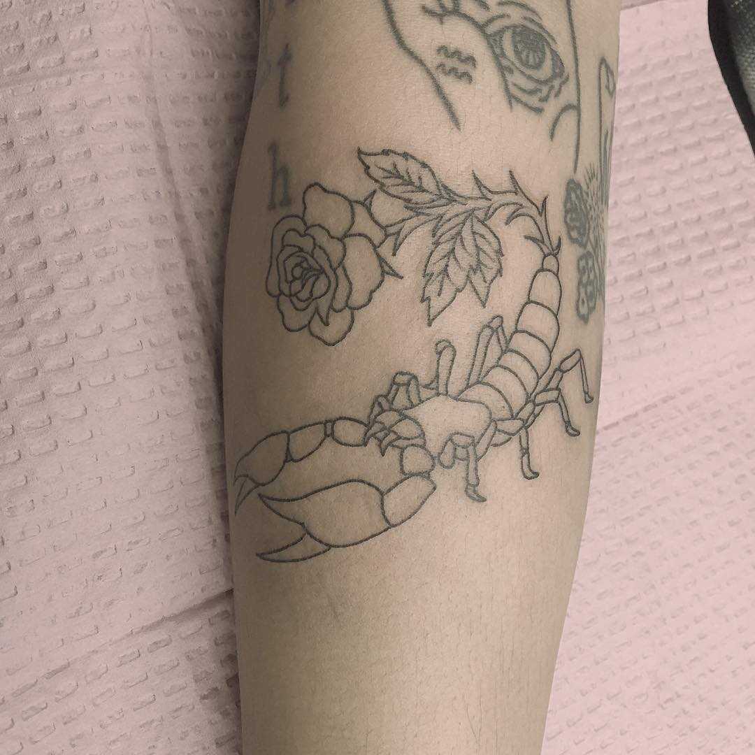 Outline scorpion and rose tattoo