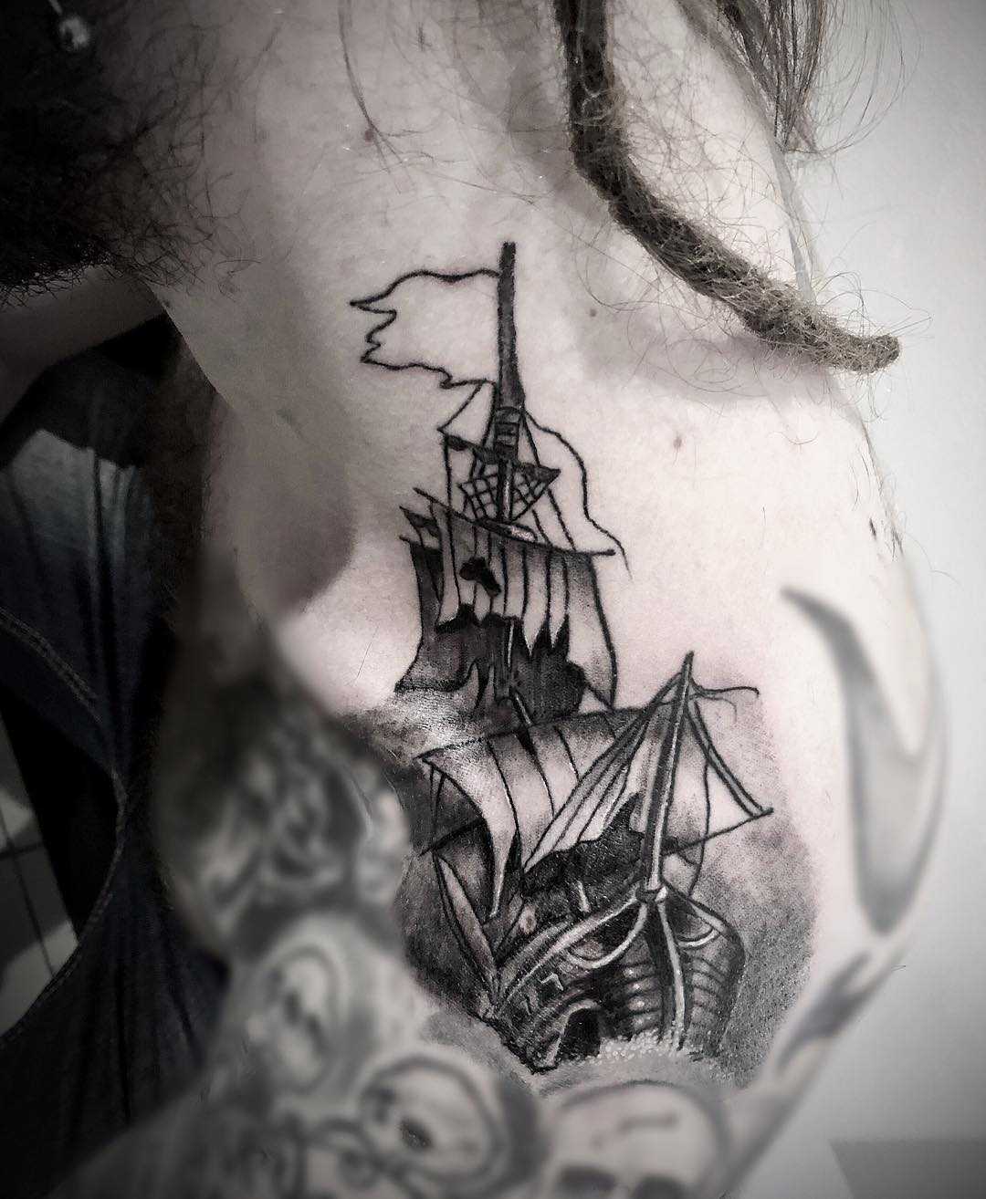 Ship tattoo on the left shoulder