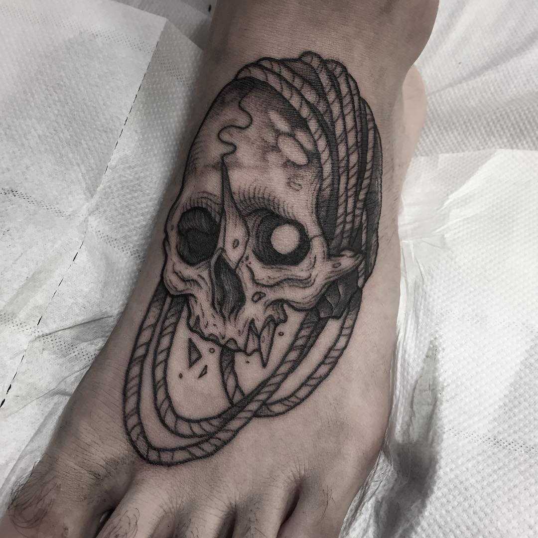 Skull and rope tattoos on foot
