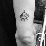 Small UFO tattoo on the triceps