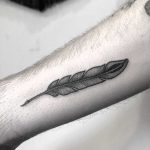 Small feather tattoo on the forearm