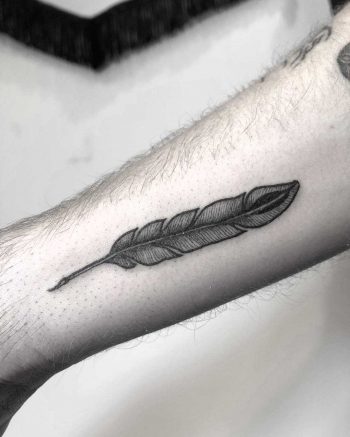 Small feather tattoo on the forearm