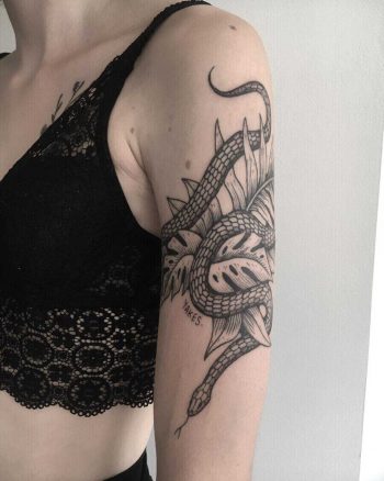Snake and greenery tattoo