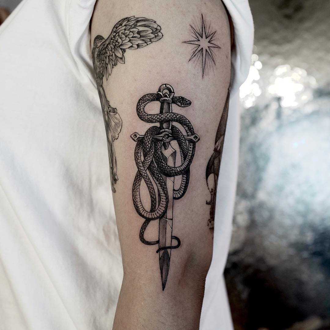 Snake and sword tattoo on the arm 