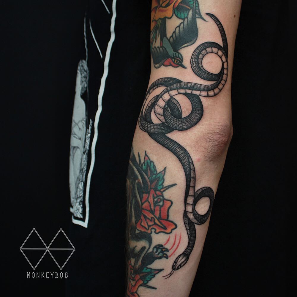 Snake tattoo on the forearm by Monkey Bob