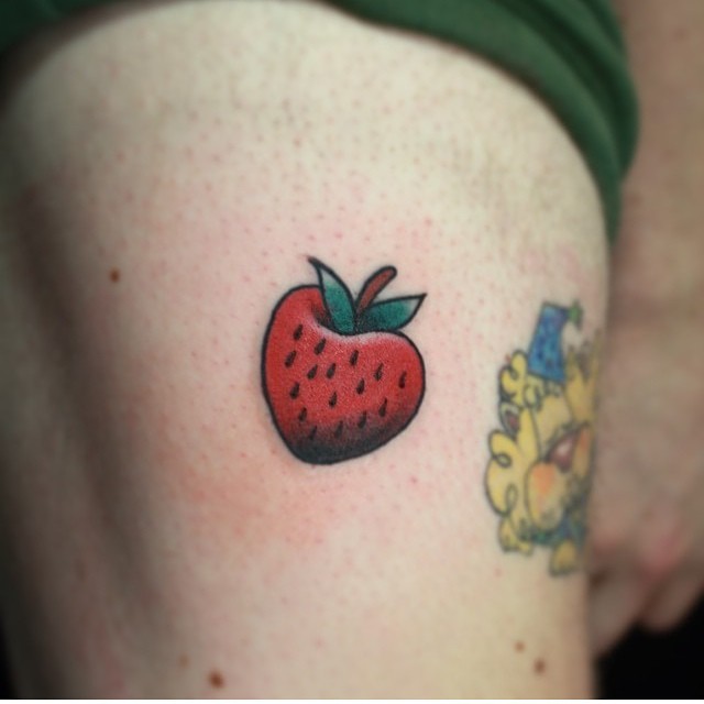 Escherian Strawberry tattoo located on the shin.