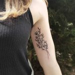 Subtle flowers tattoo on the bicep