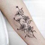Succory branch tattoo on the forearm