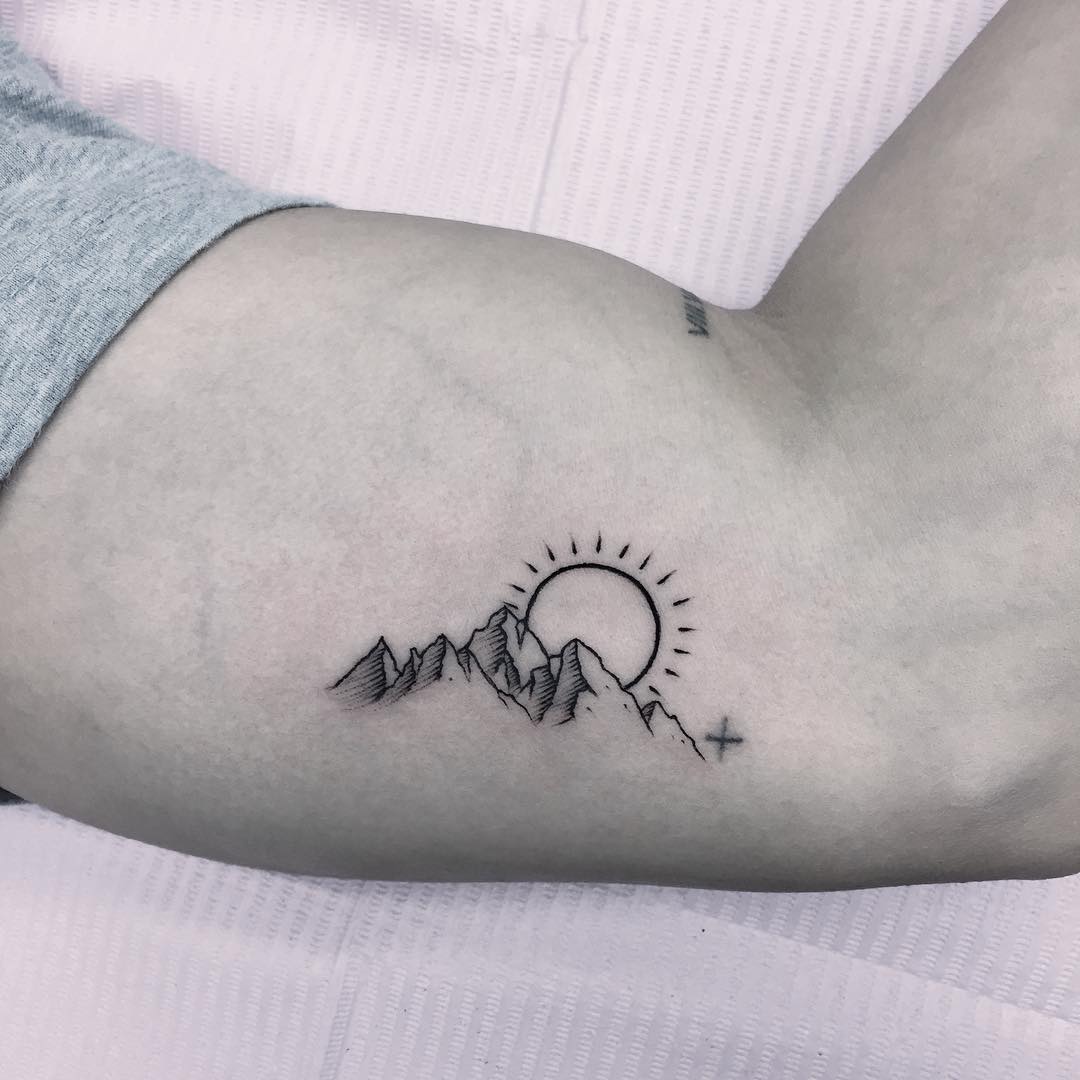 Sun and mountains tattoo
