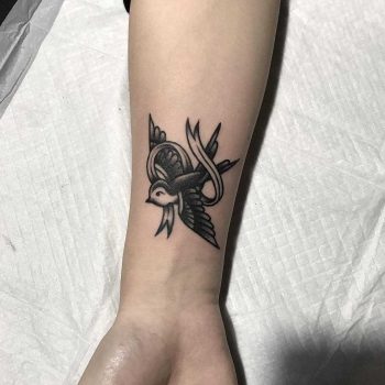 Swallow and ribbon tattoo