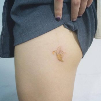 Tiny banana tattoo on the thigh