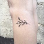 Tiny branch tattoo on the calf
