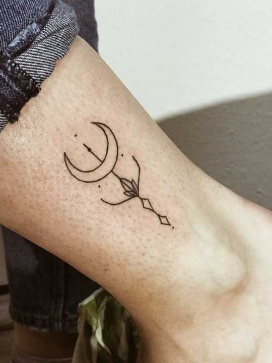 Tiny crescent moon and arrow tattoo 
