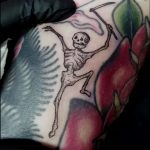 Tiny dancing skeleton tattoo