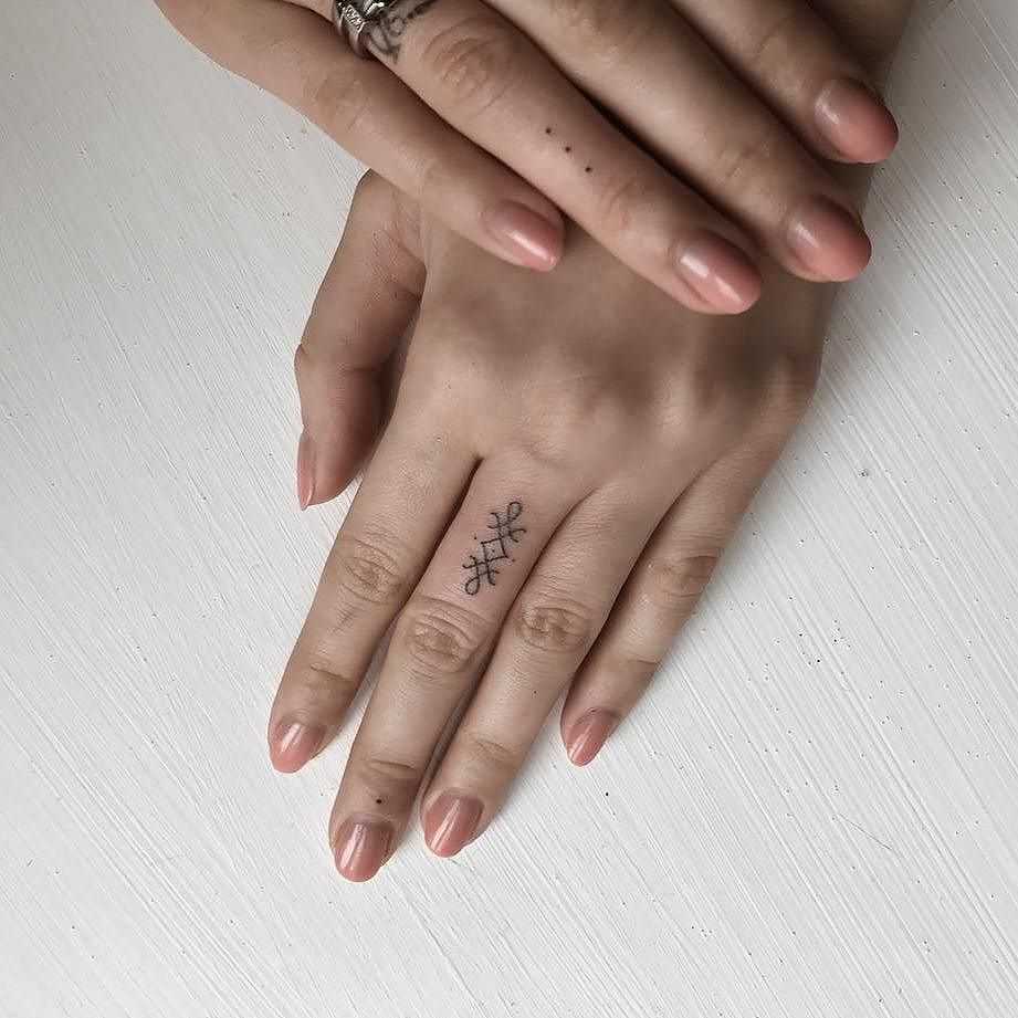 Tiny finger pokes by tattooist Ann Pokes