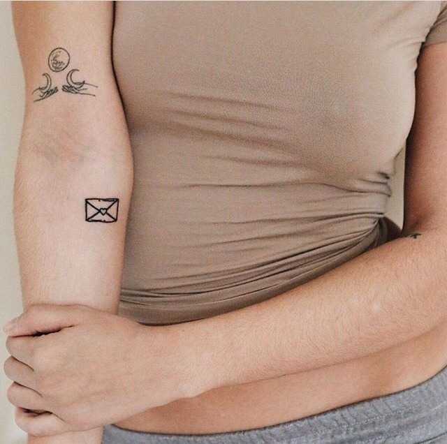 Tiny letter tattoo on the forearm