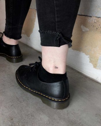 Tiny lines tattoo on the ankle