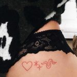 Tiny red tattoos on the hip