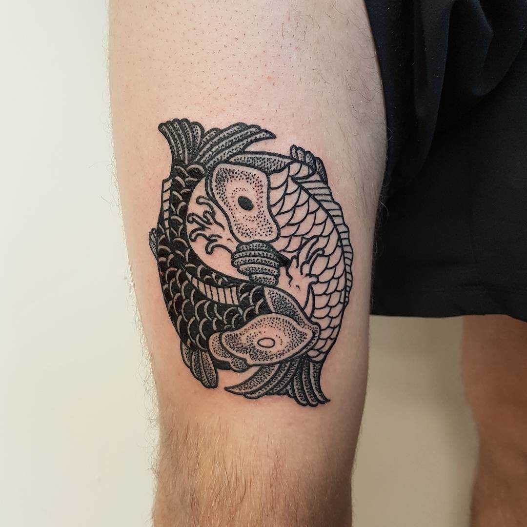 Two koi fish tattoo on the thigh