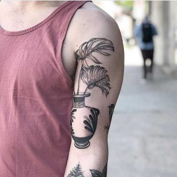 Vase with monstera leaves