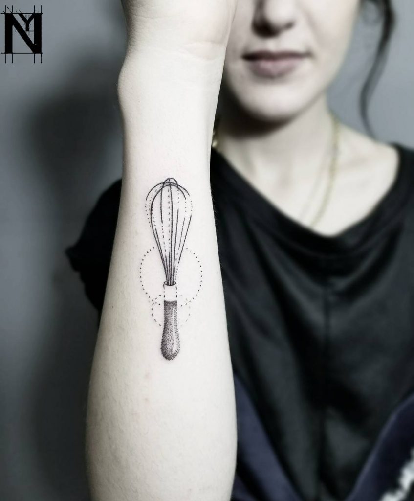Whisk tattoo on the forearm