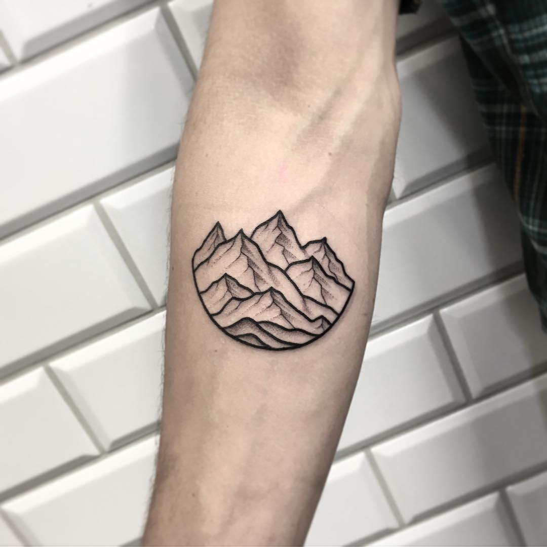 A minimalist mountains landscape tattoo